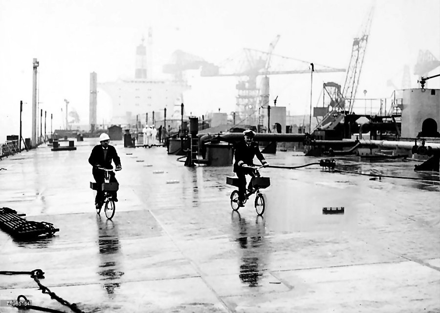 The Captain and Master on their bicycles on their inspection tour ride up
the deck of super tanker "Esso Northumbria". The ship at over 1000 feet long was the biggest ship built in England.
