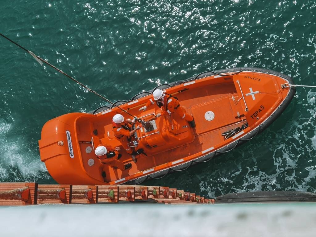 Crew onboard Merchant Navy Ships lowering Lifeboat